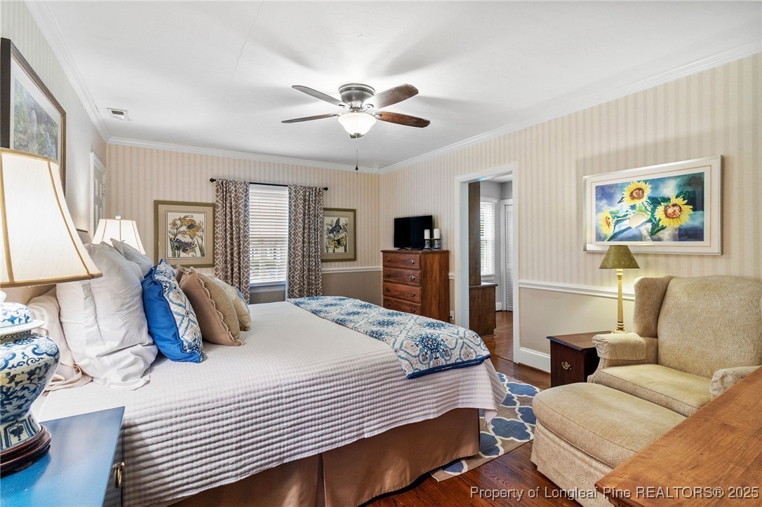 503 Rush Road Fayetteville, NC 28305 - Photo 29 of 50 a bedroom with a large bed a chandelier and dresser