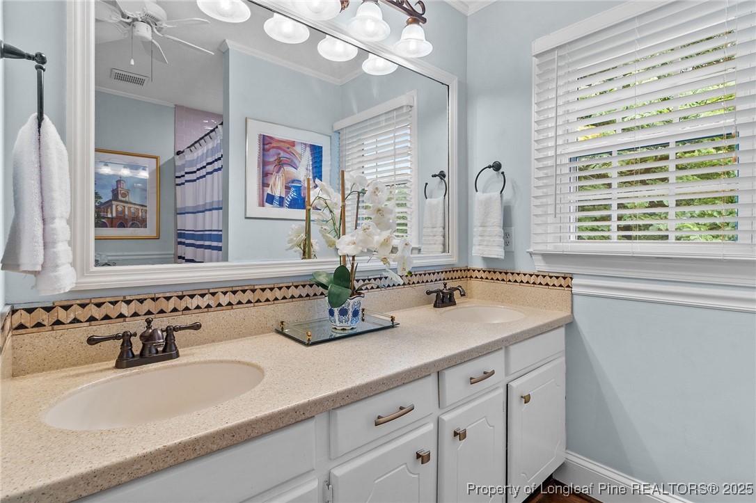 503 Rush Road Fayetteville, NC 28305 - Photo 34 of 50 a bathroom with double vanity sinks a mirror and a window
