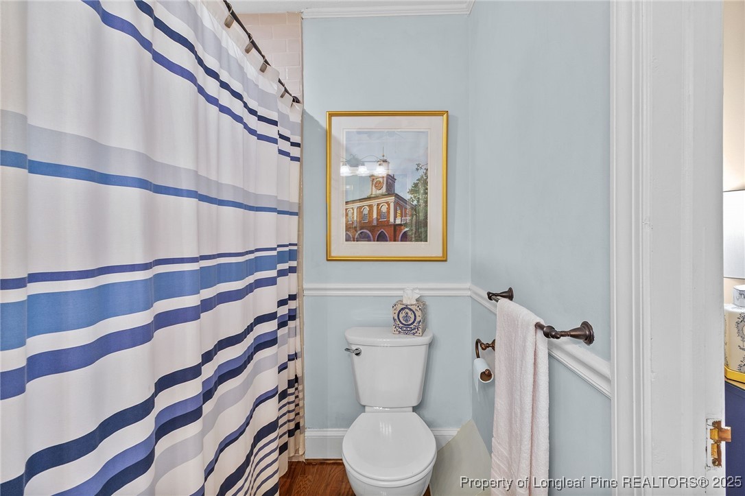 503 Rush Road Fayetteville, NC 28305 - Photo 35 of 50 a white toilet sitting next to a shower curtain