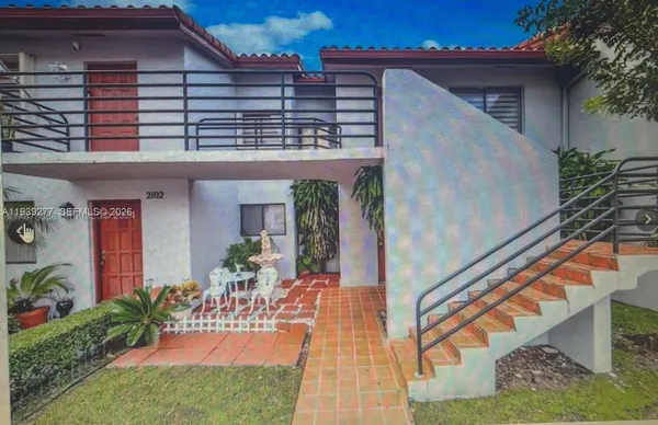 a view of a house with backyard and sitting area