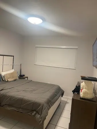 a bedroom with a bed and a lamp on table