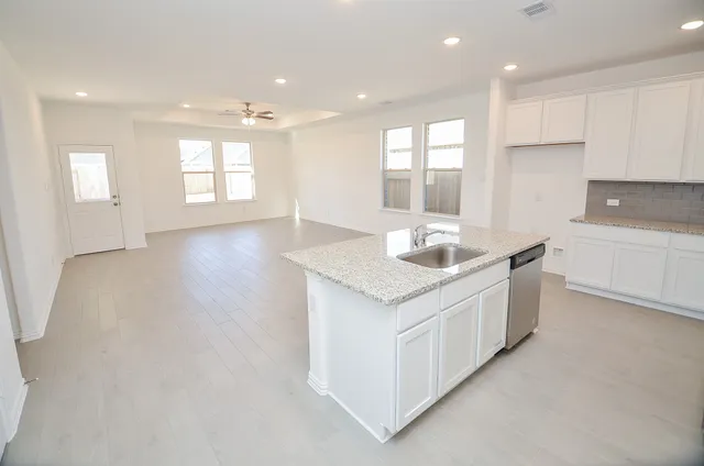 a kitchen with granite countertop white cabinets and a granite counter tops
