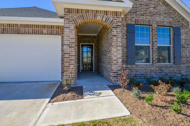 a view of a brick house with a bench