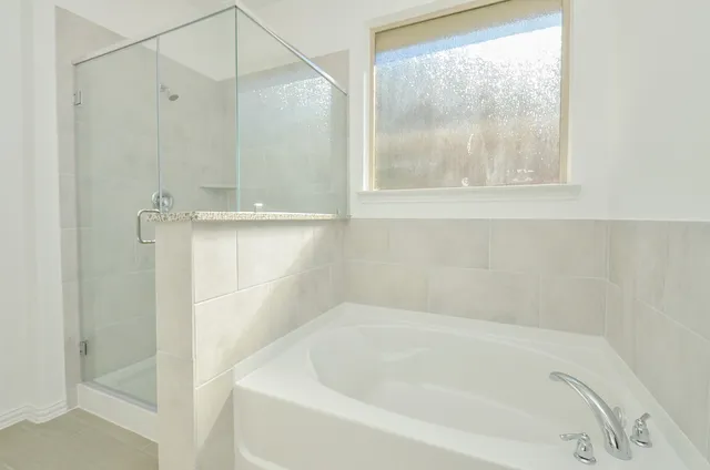 a white bath tub sitting next to a shower