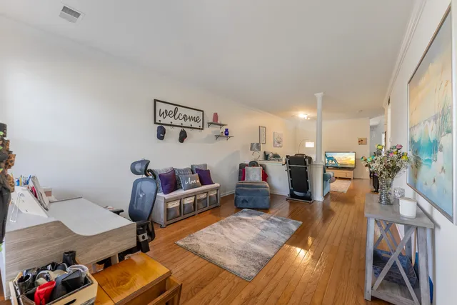 a living room with furniture and a wooden floor