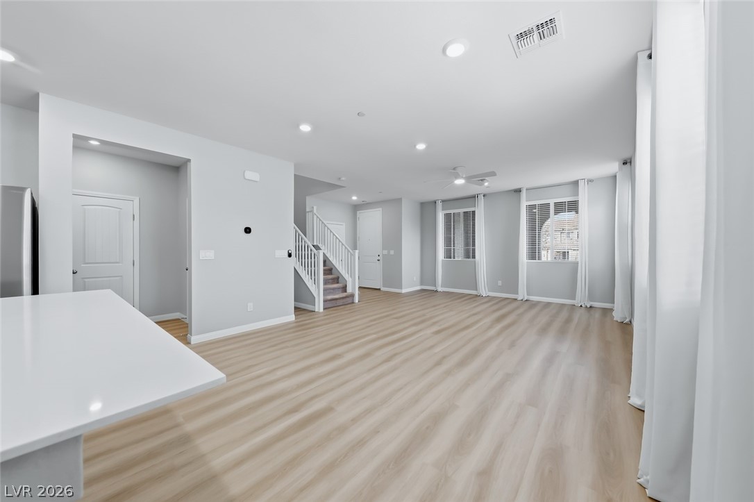 3564 Credere Lane Henderson, NV 89074 - Photo 7 of 40 Unfurnished living room featuring light wood-type flooring, recessed lighting, and a ceiling fan
