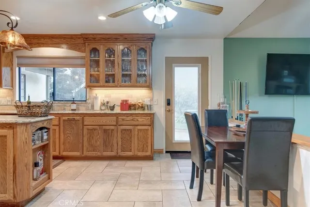 a kitchen with a stove a sink a dining table and chairs