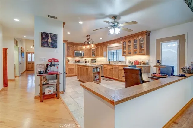 a living room with granite countertop furniture a flat screen tv and kitchen view