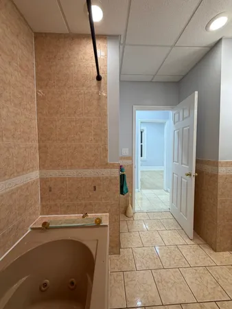 a bathroom with a tub and a shower