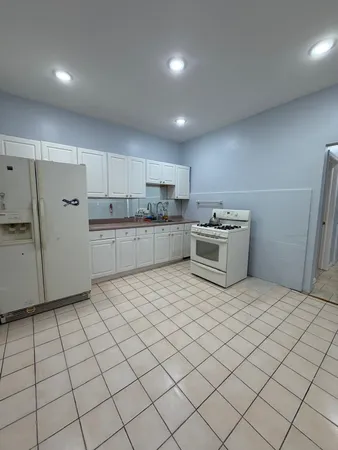 a kitchen with stainless steel appliances kitchen island granite countertop a sink and cabinets