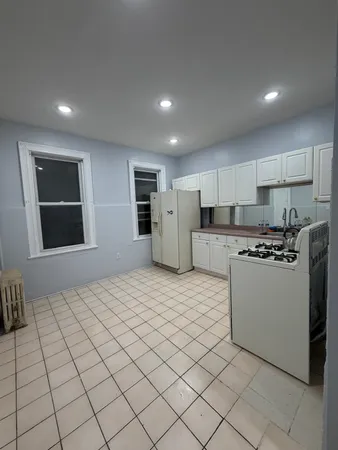 a kitchen with stainless steel appliances granite countertop a refrigerator sink and cabinets