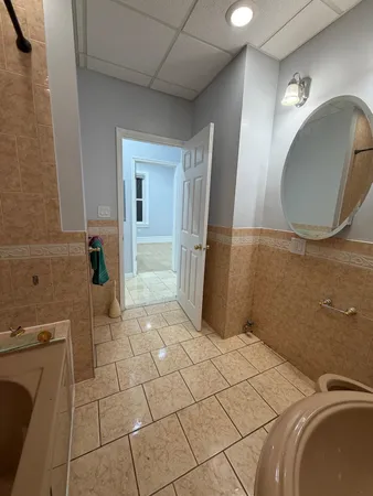 a bathroom with a sink a toilet and mirror