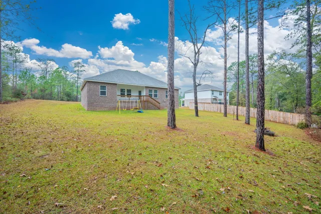 a swimming pool with some trees in the background