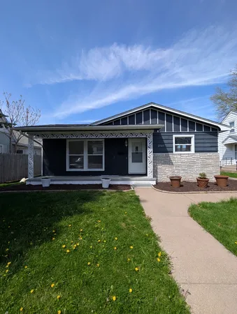 a front view of a house with a garden and yard