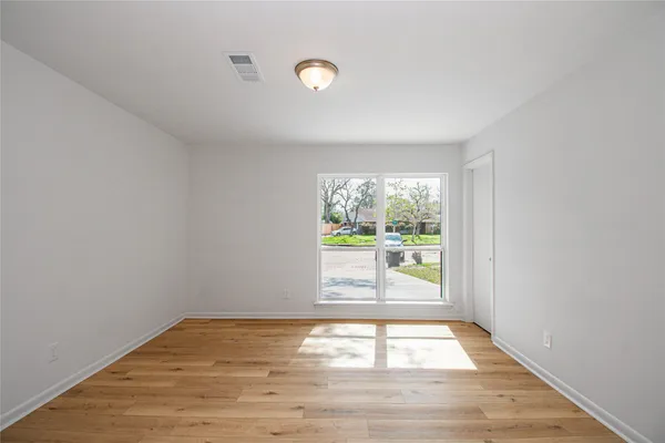 a view of a big room with wooden floor and closet
