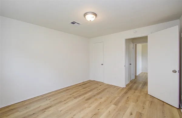 a bathroom with a granite countertop sink toilet a mirror and a bathtub