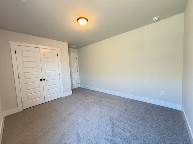 an empty room with closet area