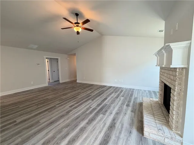 wooden floor in an empty room with a fireplace