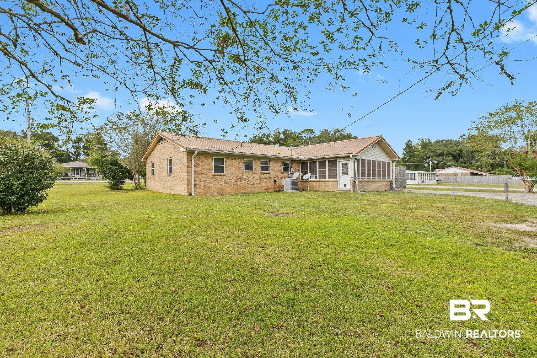 13108 6th Street Lillian, AL 36549 - Photo 32 of 39 Rear view of property with a yard, cooling unit, and a sunroom