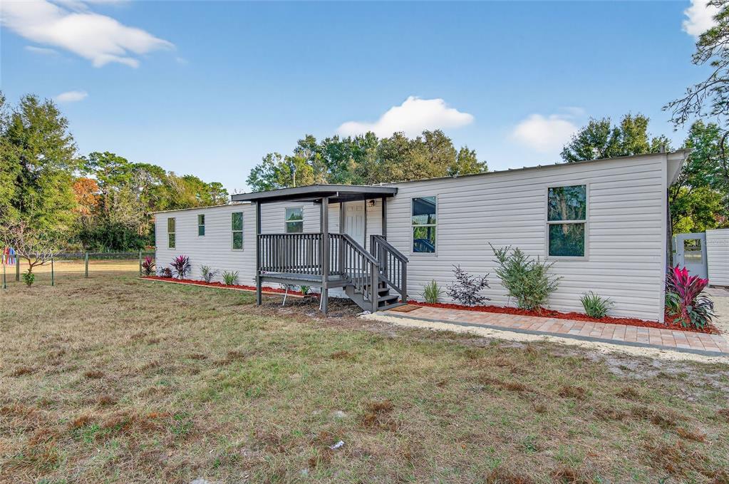 6455 West Cardinal Street Homosassa, FL 34446 - Photo 13 of 38 a view of a house with backyard and garden