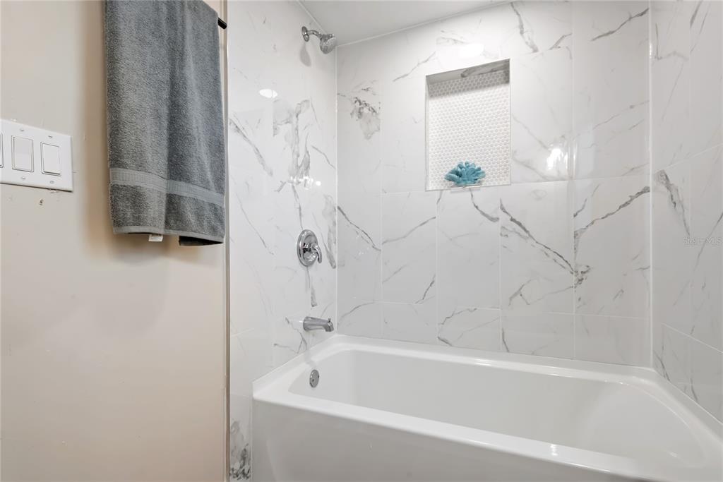 6455 West Cardinal Street Homosassa, FL 34446 - Photo 31 of 38 a bathroom with a bathtub and a shower