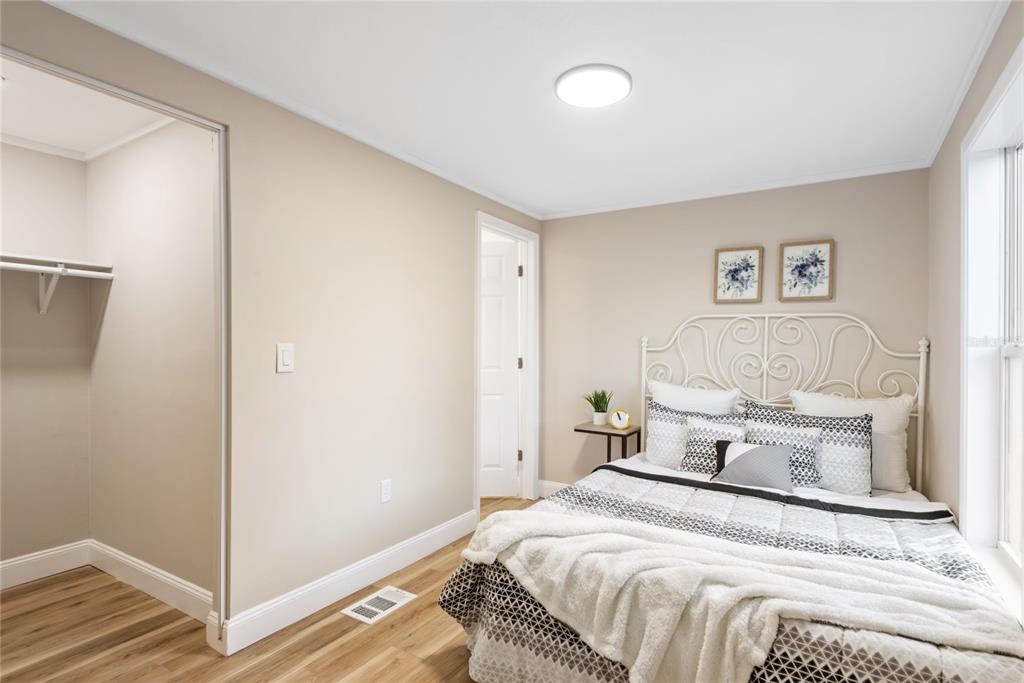 6455 West Cardinal Street Homosassa, FL 34446 - Photo 35 of 38 a bedroom with a bed and wooden floor