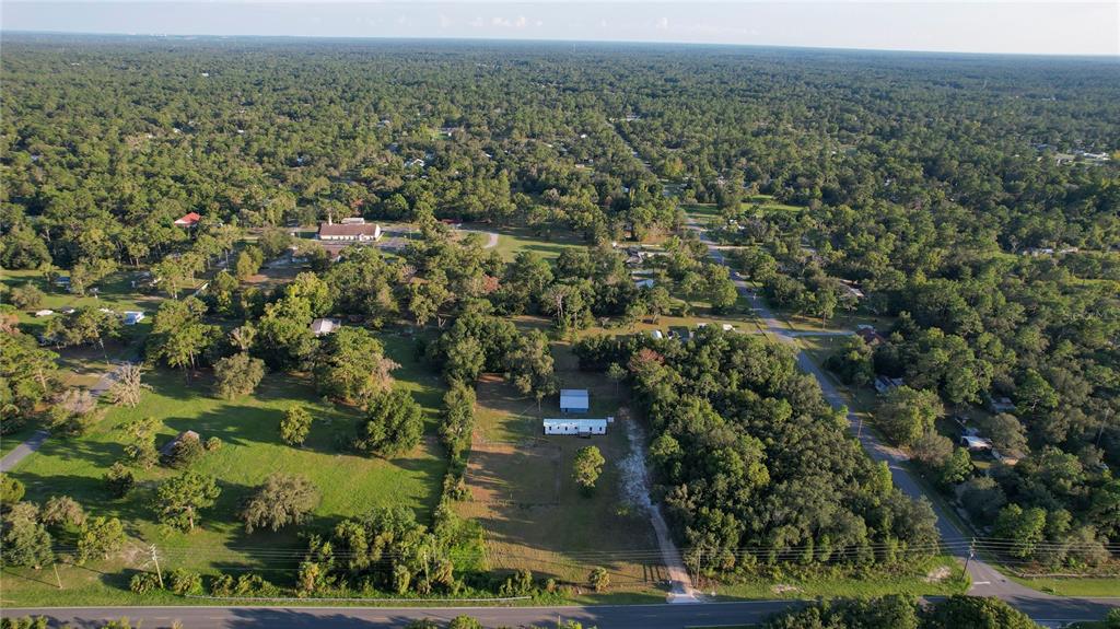6455 West Cardinal Street Homosassa, FL 34446 - Photo 38 of 38 an aerial view of residential houses with outdoor space and trees