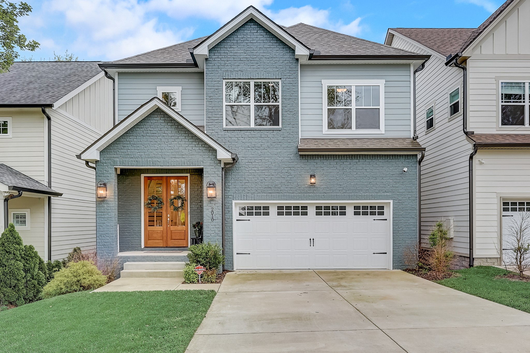 a front view of a house with a yard and garage
