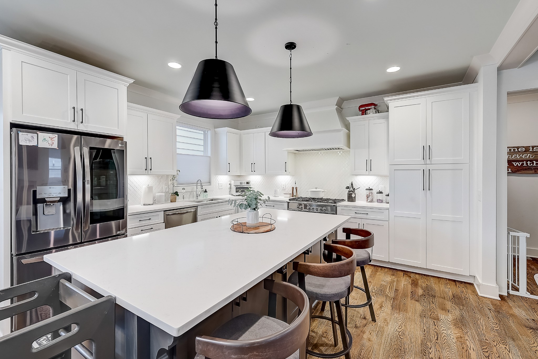 2010 Sheridan Road Nashville, TN 37206 - Photo 19 of 62 a kitchen with stainless steel appliances a dining table chairs and white cabinets