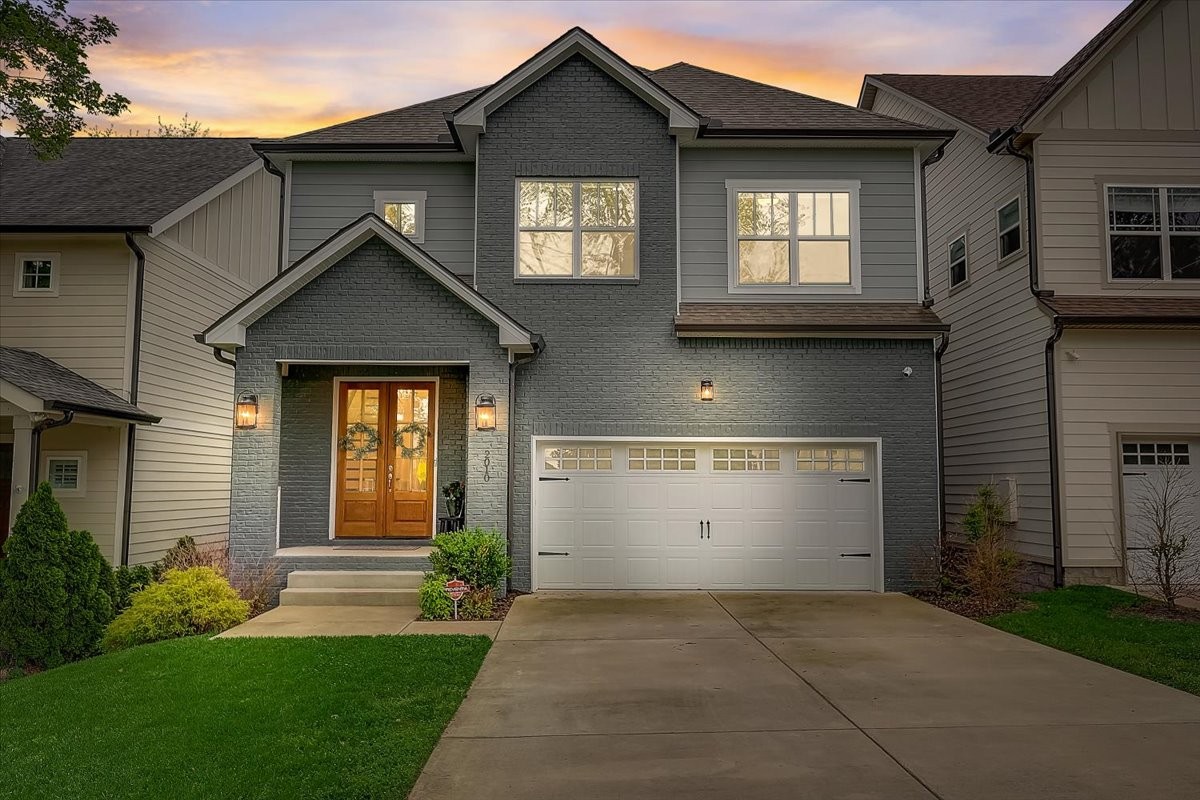 2010 Sheridan Road Nashville, TN 37206 - Photo 2 of 62 a view of a house with brick walls and a yard with plants