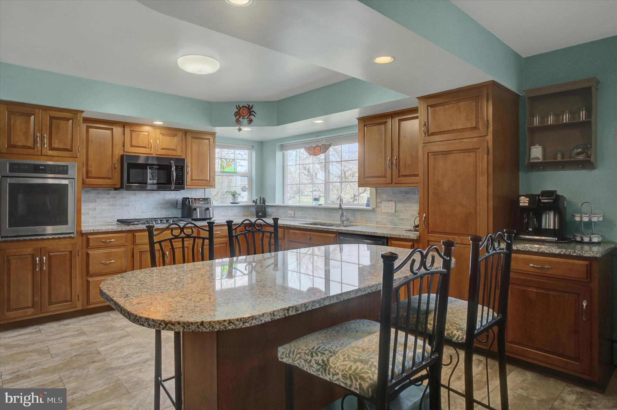 6612 Moulstown Road Hanover, PA 17331 - Photo 14 of 84 a kitchen with granite countertop a table chairs microwave and cabinets