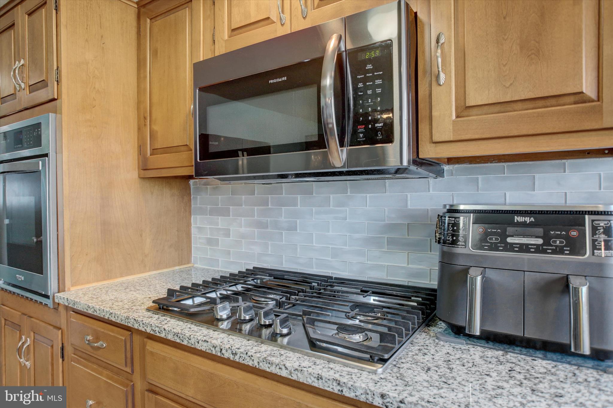 6612 Moulstown Road Hanover, PA 17331 - Photo 16 of 84 a kitchen with granite countertop a stove and a microwave