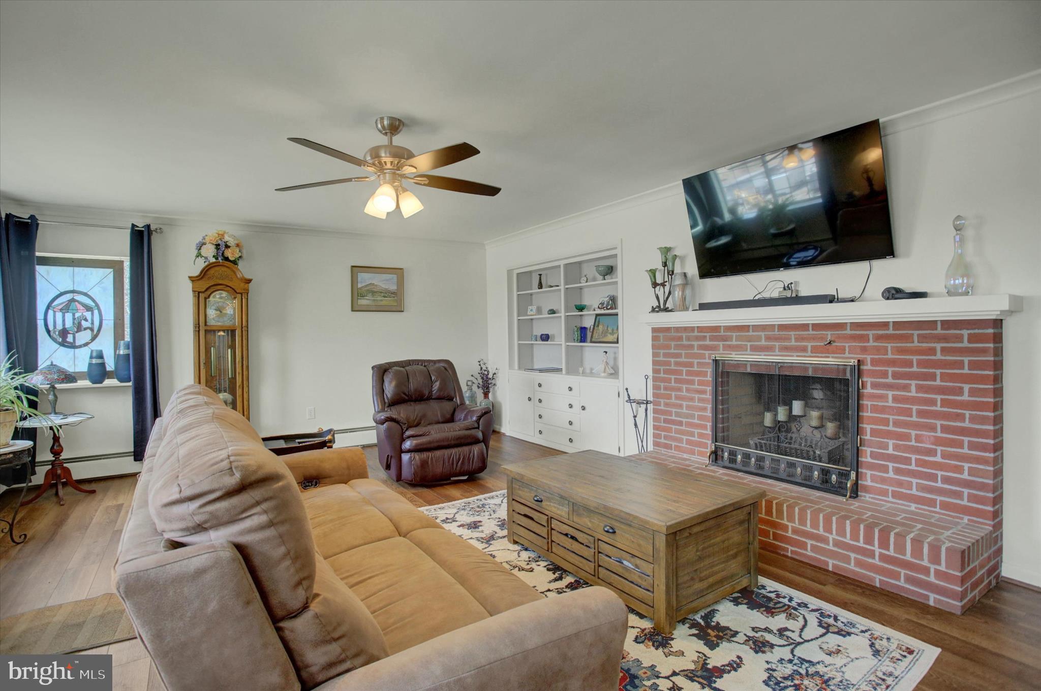 6612 Moulstown Road Hanover, PA 17331 - Photo 7 of 84 a living room with furniture a flat screen tv and a fireplace