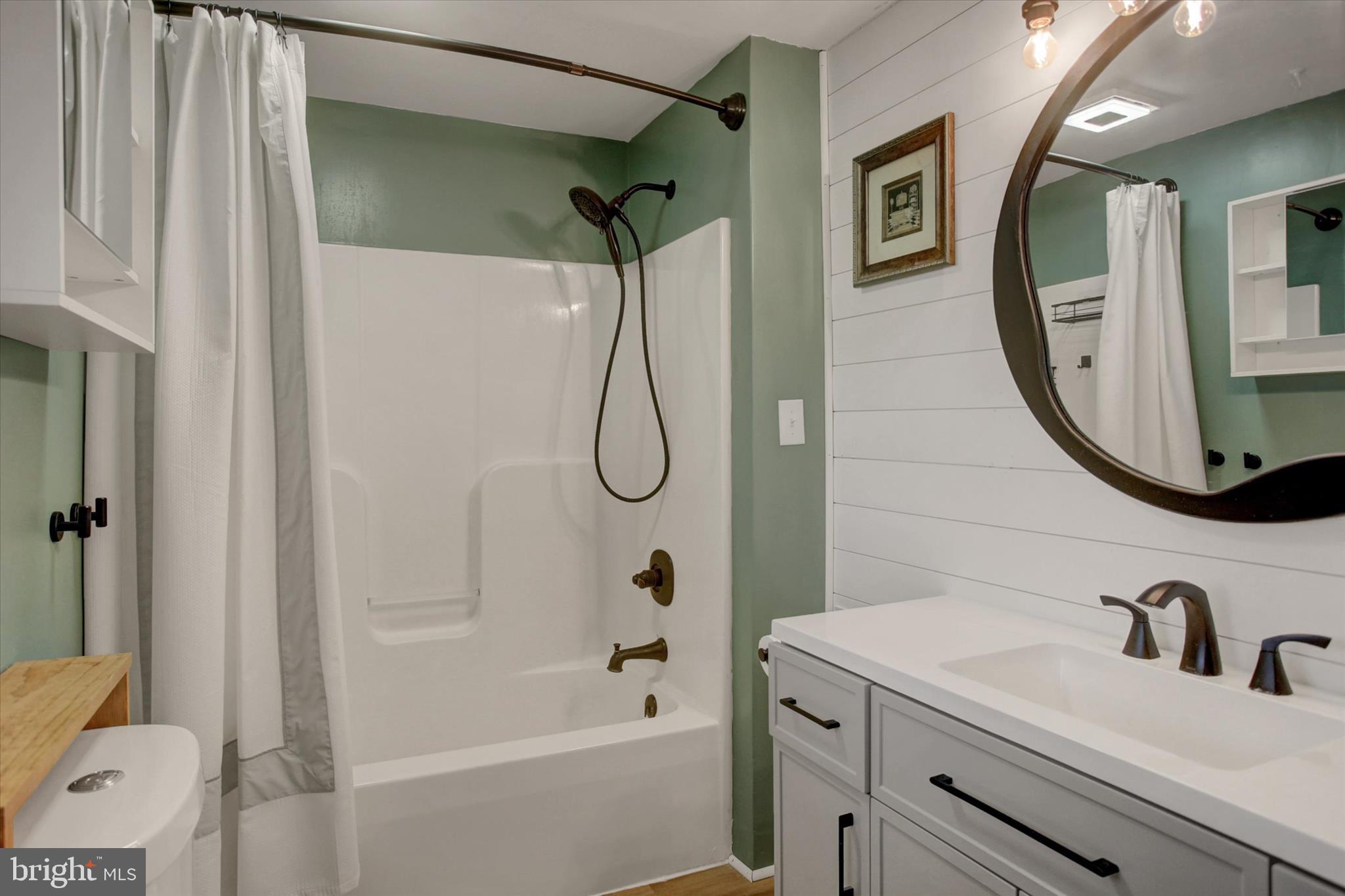 6612 Moulstown Road Hanover, PA 17331 - Photo 73 of 84 a bathroom with a granite countertop sink a mirror a vanity and a bathtub