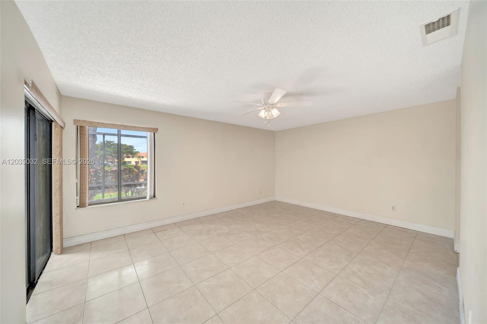 5223 Gate Lake Road, Unit 5223 Tamarac, FL 33319 - Photo 21 of 37 an empty room with windows