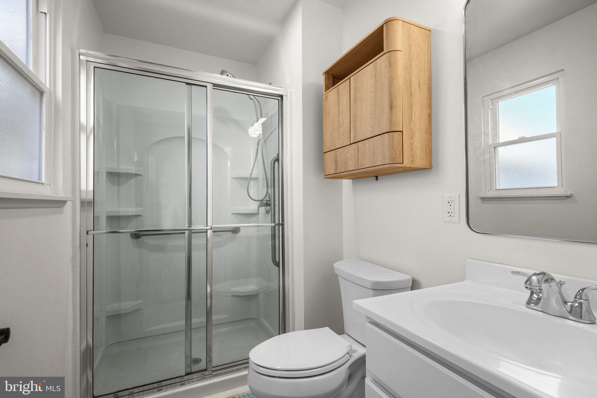 1420 Gilbert Road Arnold, MD 21012 - Photo 12 of 23 a bathroom with a sink a mirror a toilet and shower
