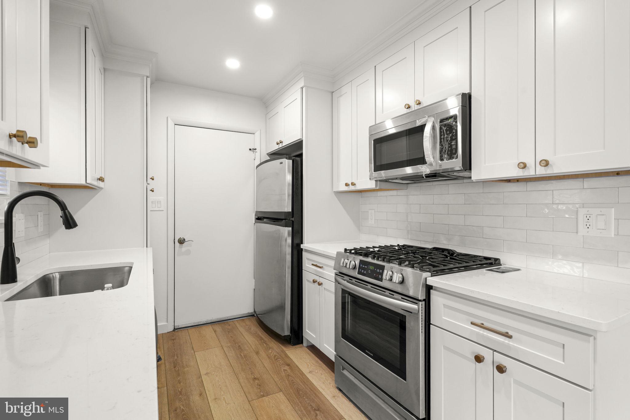 1420 Gilbert Road Arnold, MD 21012 - Photo 2 of 23 a kitchen with stainless steel appliances granite countertop a stove a microwave and a refrigerator