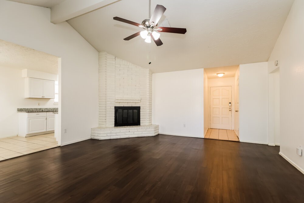 13411 Reads Court Houston, TX 77015 - Photo 4 of 16 a view of an empty room with wooden floor and a fireplace