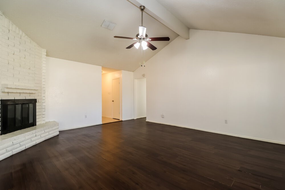 13411 Reads Court Houston, TX 77015 - Photo 5 of 16 an empty room with wooden floor ceiling fan and windows