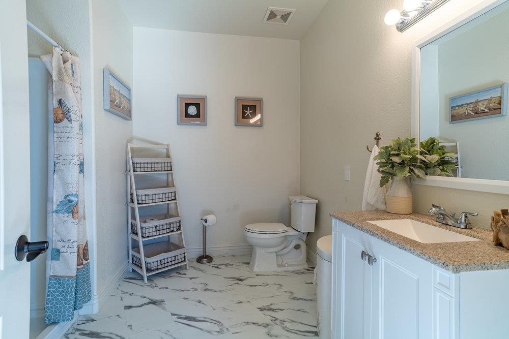 2985 Day Road Gilroy, CA 95020 - Photo 93 of 100 a bathroom with a granite countertop sink toilet and shower