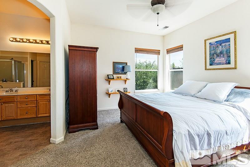 1170 El Campo Court Reno, NV 89521 - Photo 8 of 14 a spacious bedroom with a large bed and a dresser