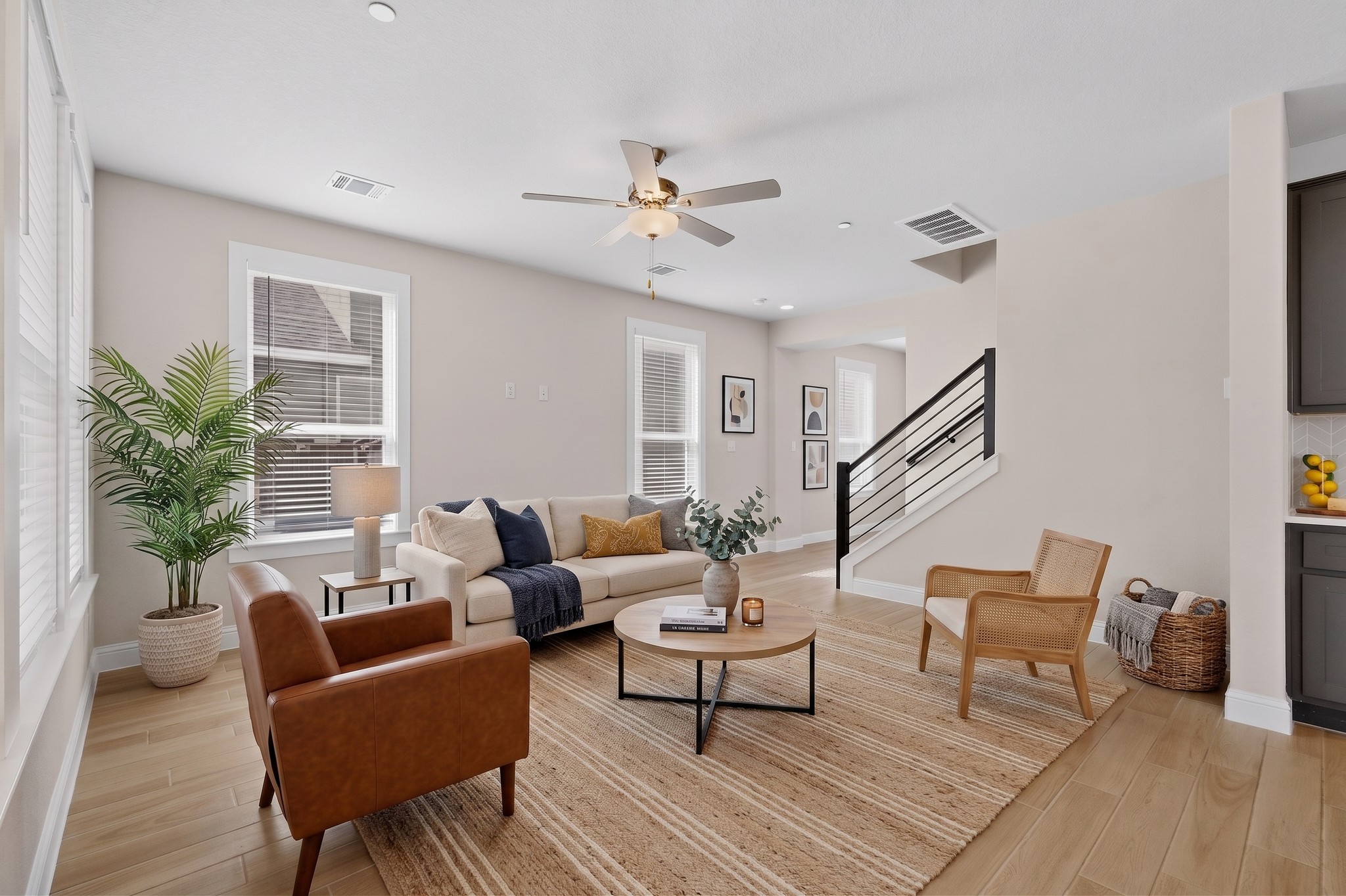 2605 Sam Bass Road, Unit 9 Round Rock, TX 78681 - Photo 7 of 38 A well-lit gathering space with hard-surface flooring and a contemporary staircase.