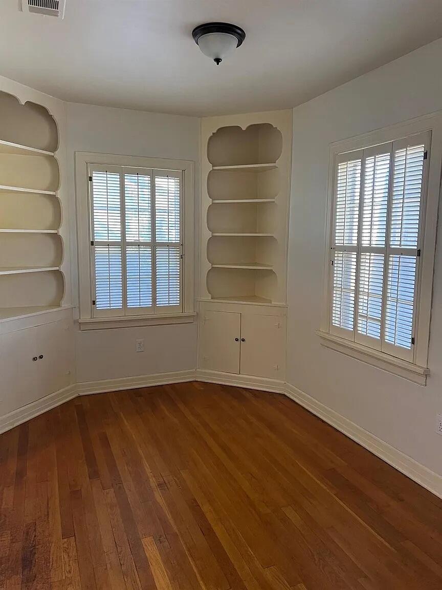 3013 22nd Street Lubbock, TX 79410 - Photo 4 of 9 an empty room with wooden floor and windows