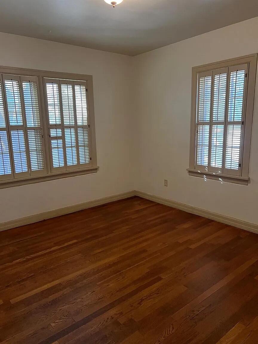3013 22nd Street Lubbock, TX 79410 - Photo 9 of 9 a view of an empty room with wooden floor and a window