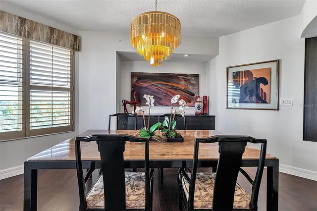 a living room with patio furniture and a floor to ceiling window