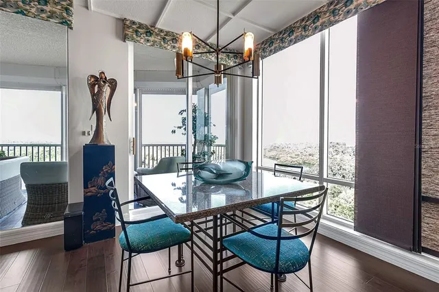 a bedroom with furniture and a large window