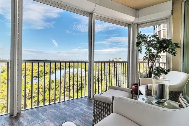 a living room with furniture a flat screen tv and a bookshelf