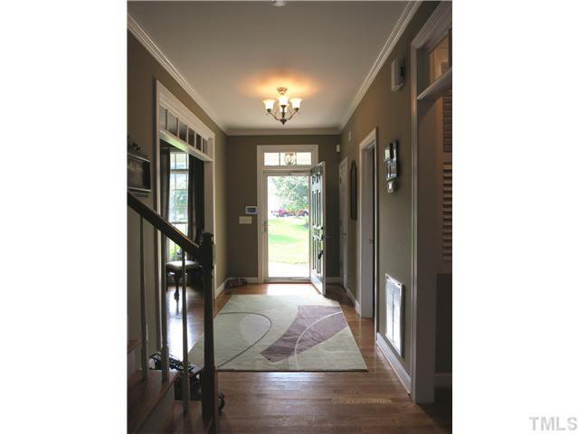 1627 Weatherford Circle Raleigh, NC 27604 - Photo 3 of 25 This home features hardwood flrs throughout main level (except MBR, Master Bath & Laundry Rm), interior & exterior transom windows, crown & chair rail molding. The gracious Foyer has a brushed nickel light fixture & coat closet.