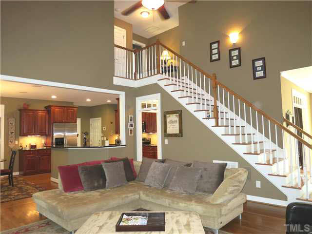 1627 Weatherford Circle Raleigh, NC 27604 - Photo 9 of 25 This view of the Living Rm shows the open staircase & landing, and the adjacent Kitchen & eat-at bar.