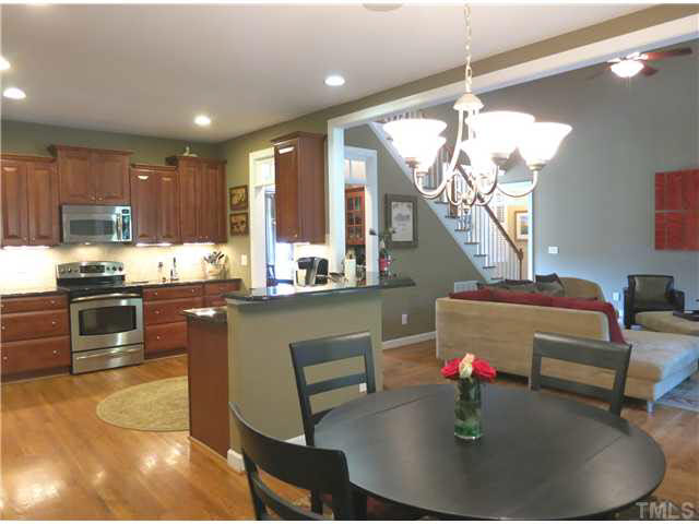 1627 Weatherford Circle Raleigh, NC 27604 - Photo 10 of 25 The open Kitchen offers granite ctrs, lots of 42" cherry cabinets, SS appls (smooth-top range, MW & DW), stone subway tile backsplash, under cabinet & recessed lighting, sunny Bfast area, WI Pantry & angled eat-at bar.